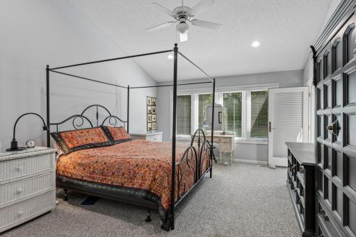 Light-filled main level primary bedroom suite picturesque window views â wake up to nature every morning.