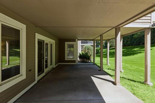 Covered lower level patio connects indoor and outdoor living â the perfect spot for morning coffee.