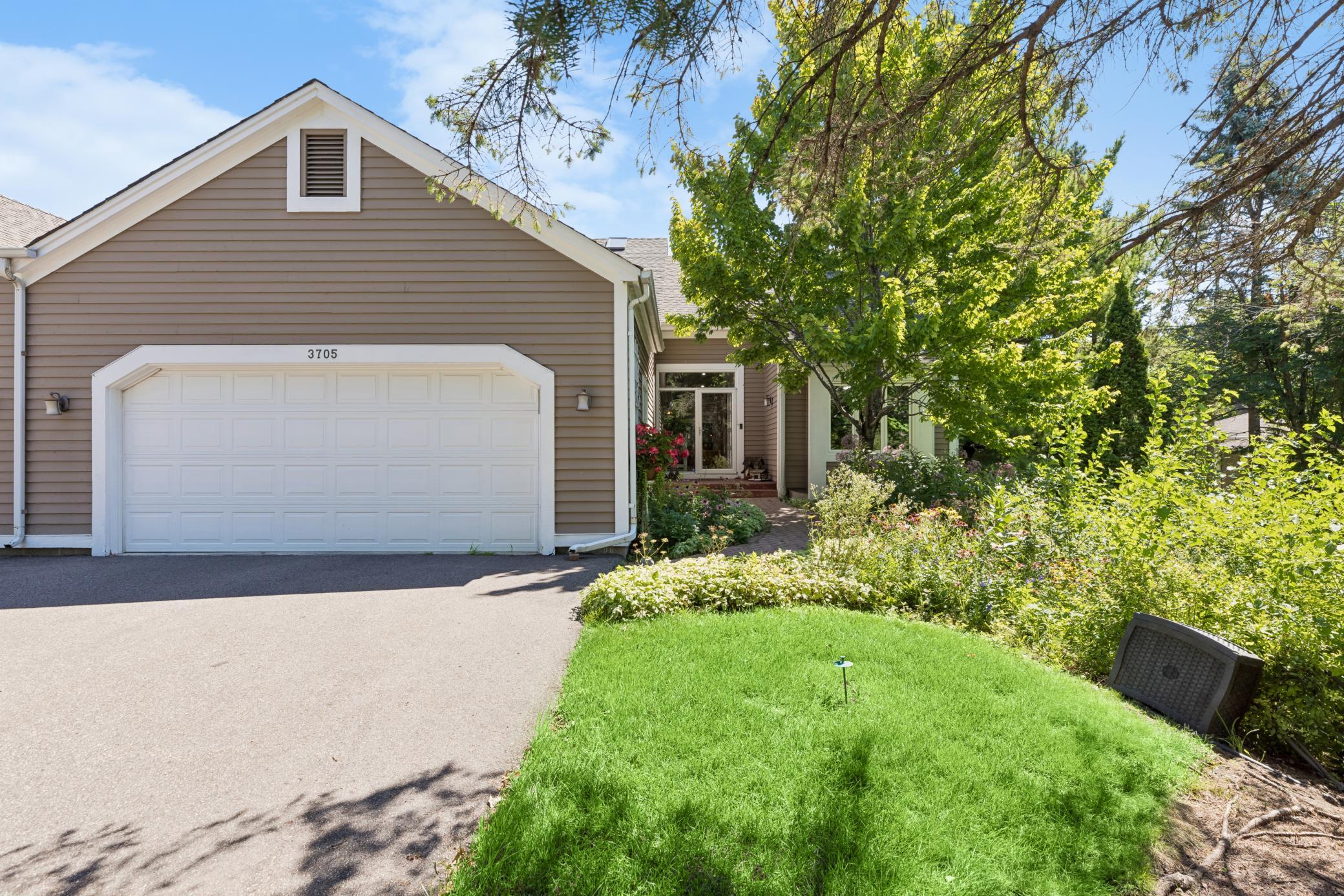 Welcome to this sought-after corner townhome backing directly onto the golf course, with private, tree-lined views right outside your door.