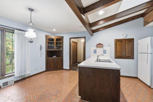 Kitchen peninsula and breakfast nook with built in cabinetry.