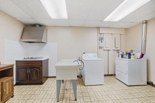 Oversized, lower level laundry with built-in grill and vent hood.