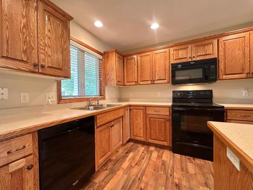 Like new condition custom cabinets, laminate wood floors and matching black appliances makes this kitchen easy to maintain and it functions well.