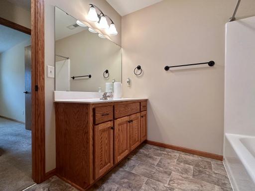 Another look at this roomy bathroom with vinyl tile flooring.