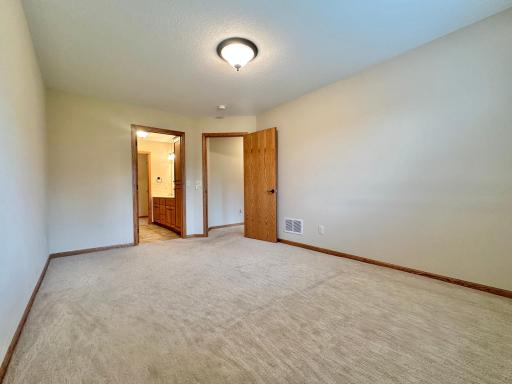Another angle of the owners suite revealing the private bath which precedes the walk in closet.