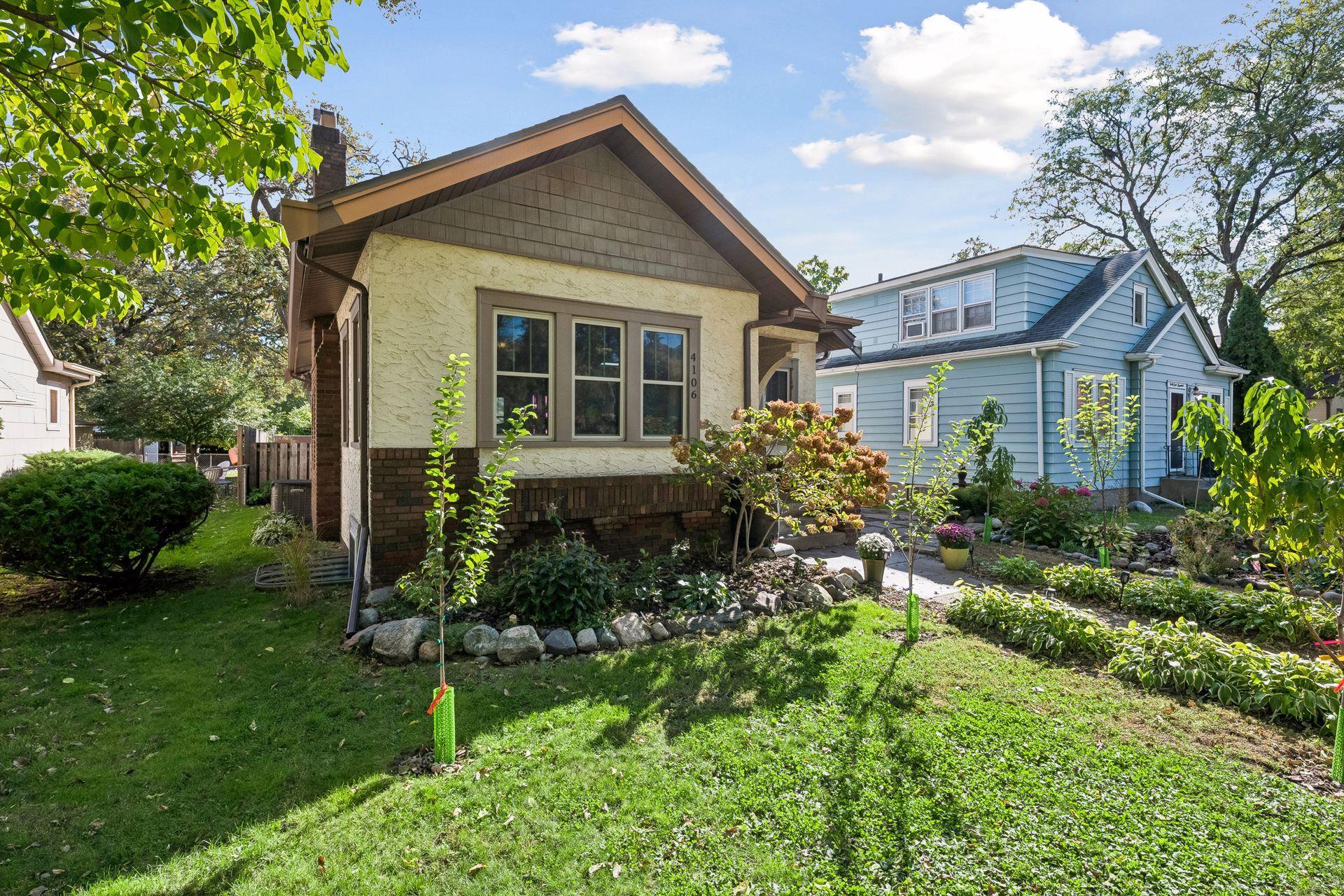 Craftsman details like shingle accents in the gable, brick trim, and a triple front window give this home lasting curb appeal. Thoughtful landscaping wraps around the front and side yards.
