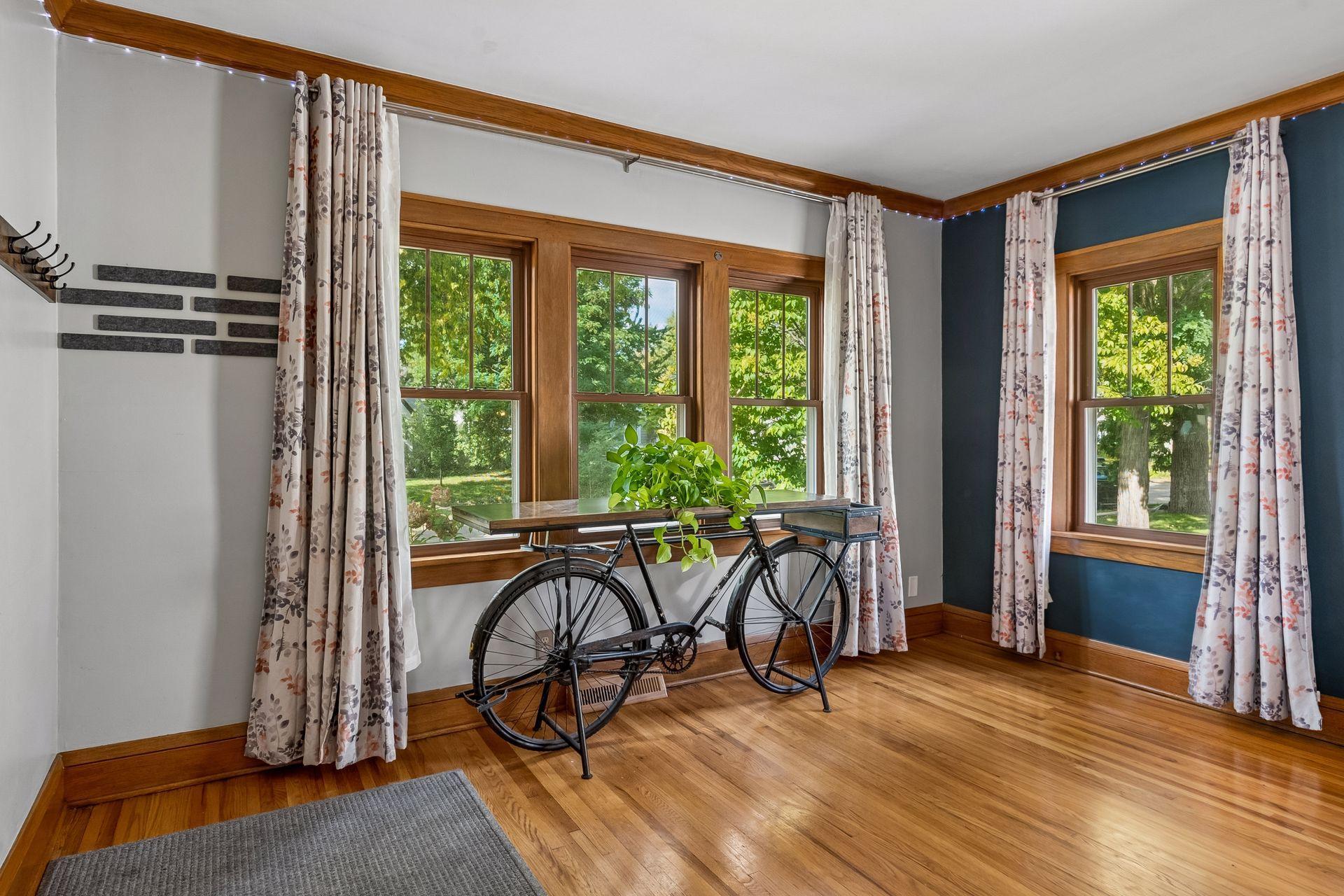 Original-style double-hung windows frame leafy views of the neighborhood. This sunny corner is perfect for a reading nook, a desk, or a favorite piece of furniture.