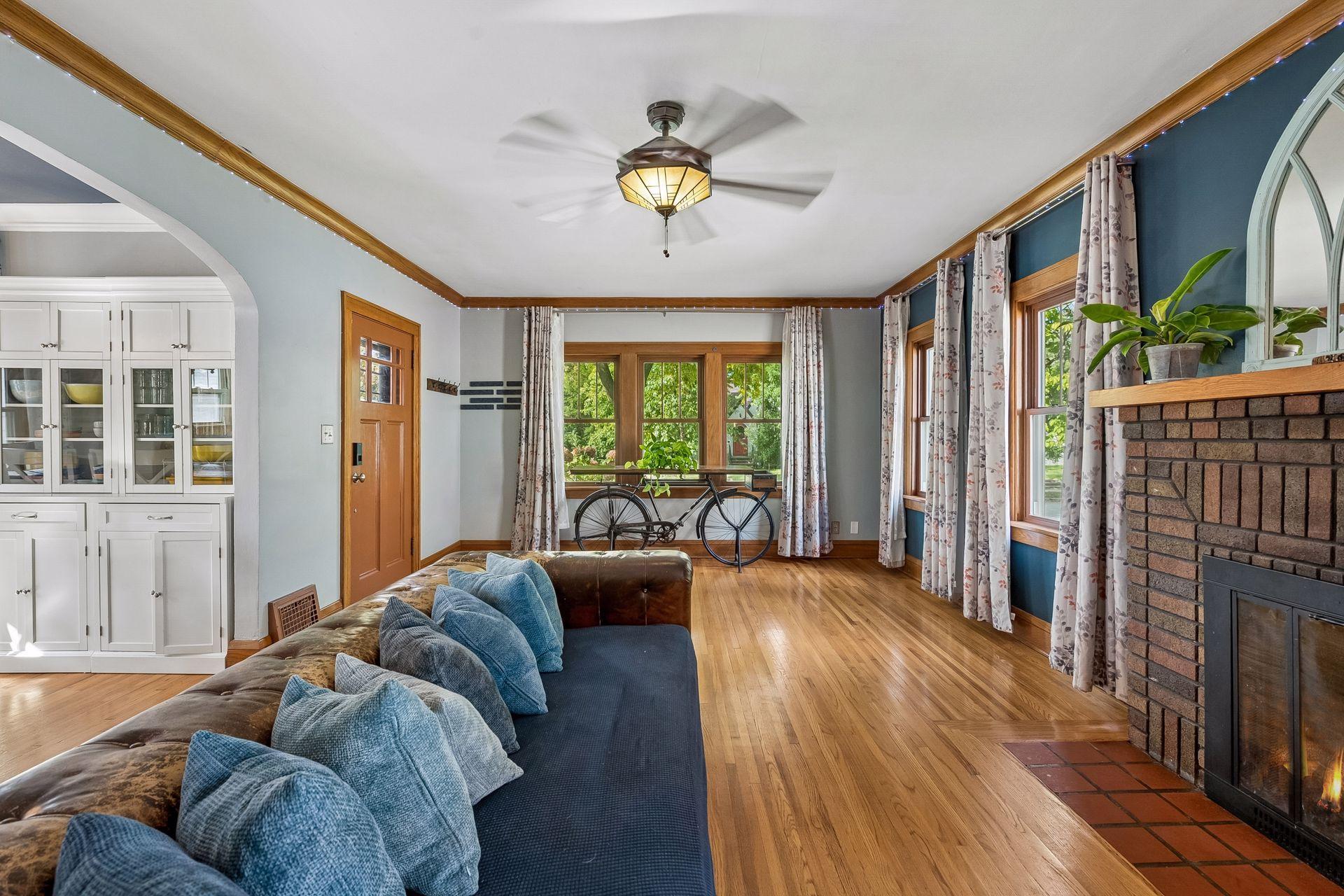 Hardwood floors run the full length of the living room, from the fireplace to the front windows. There's plenty of room to arrange furniture for movie nights or entertaining.