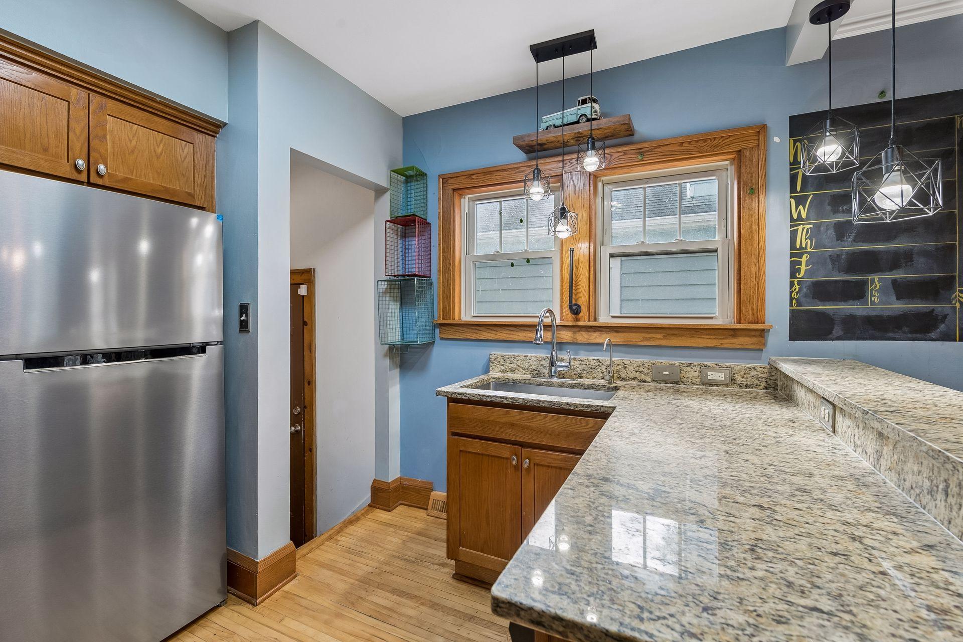Granite counters wrap around the kitchen, with a deep sink under a pair of windows. The reverse osmosis water filter gives you clean drinking water right at the tap.