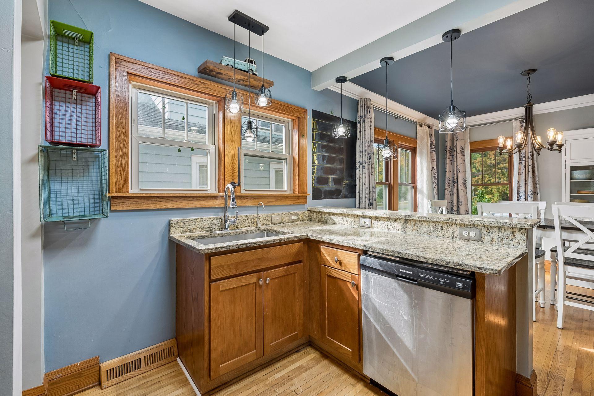 A newer dishwasher, plenty of oak cabinetry, and a raised granite bar that looks into the dining room make this kitchen both practical and social.