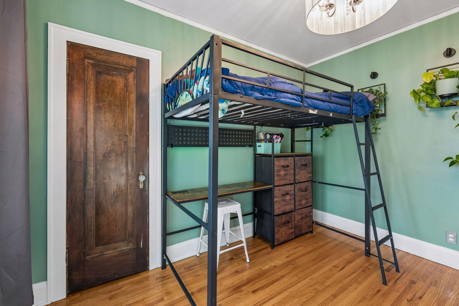 A classic wood panel door with vintage hardware opens to the closet. The room has plenty of space for a bed, desk, and storage.