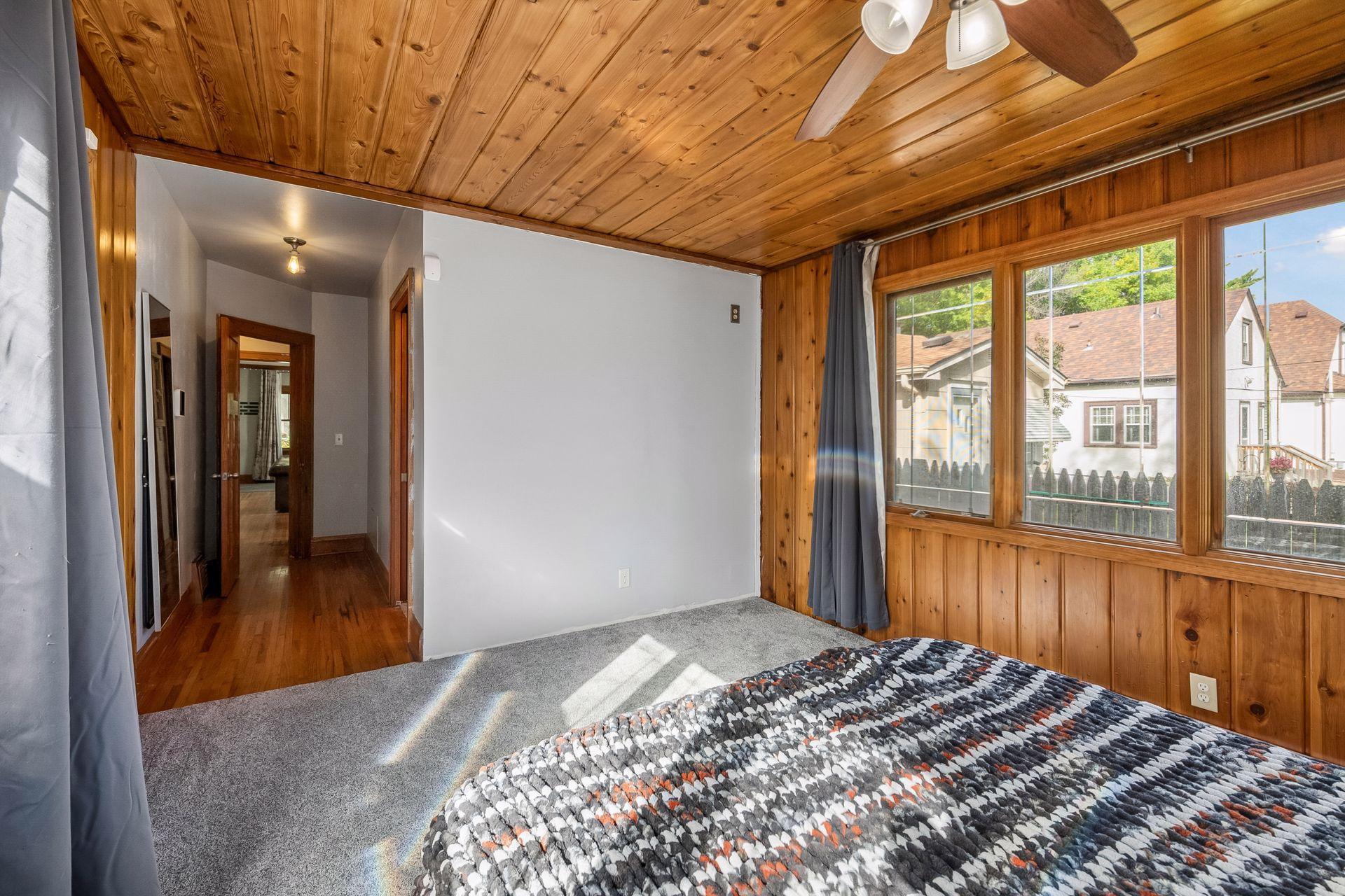 Windows along two walls bring in lots of natural light. The bedroom sits just off the main hallway, close to the main level bath.