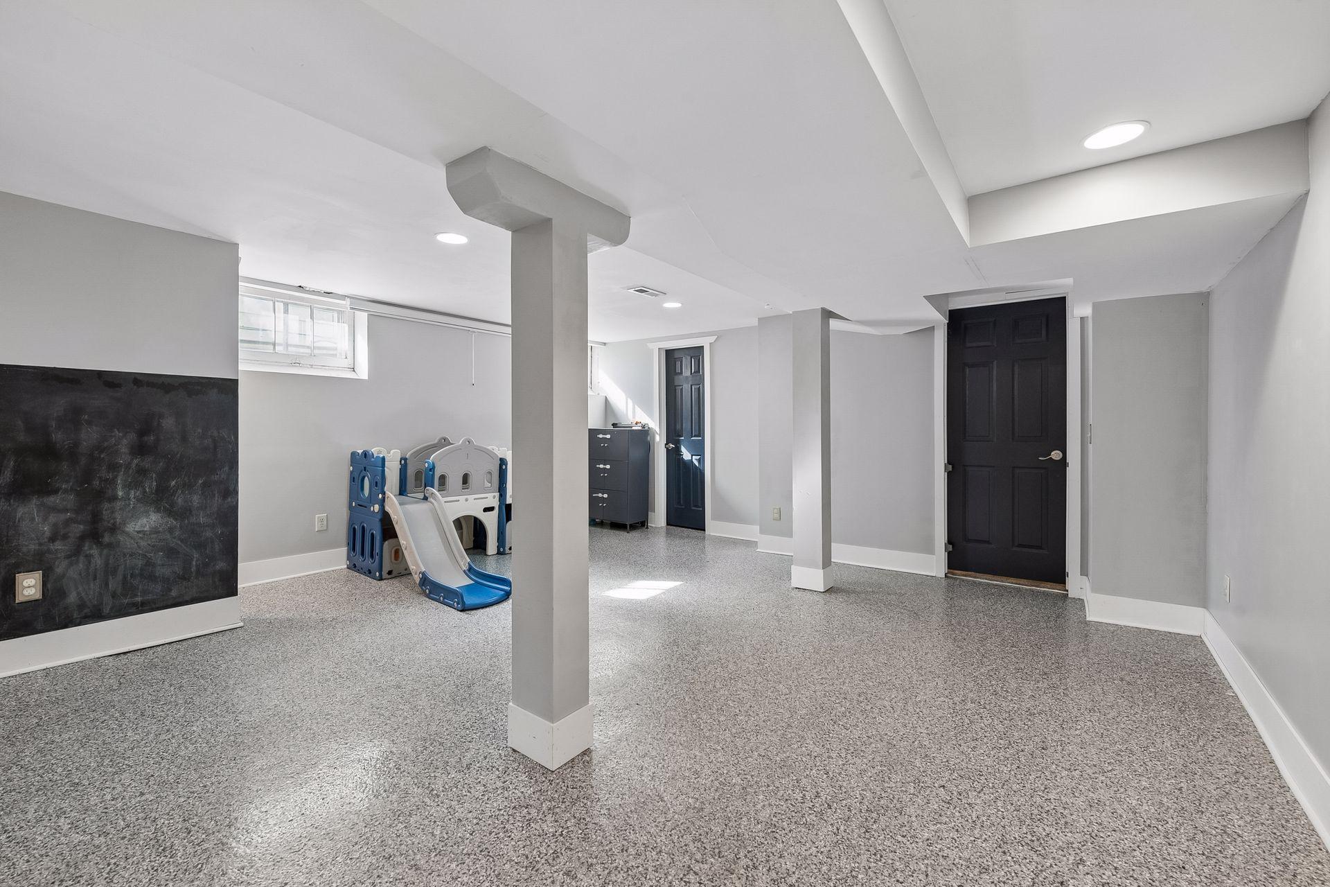 The finished lower level has fresh flooring, recessed lighting, and bright, neutral walls. There's plenty of room for a family room, home gym, or hobby space.