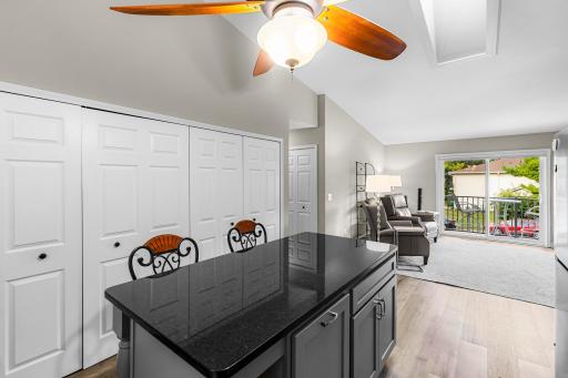 Closed bi-folds conceal furnace, HWH, washer, dryer and storage. Granite breakfast bar with storage underneath.