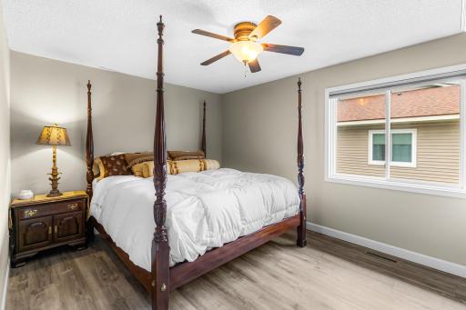 Plenty of room for a king size bed (pictured). Ceiling fan. Laminate flooring. Neutral colors. Walk-in closet with new shelving for storage and hanging room too.