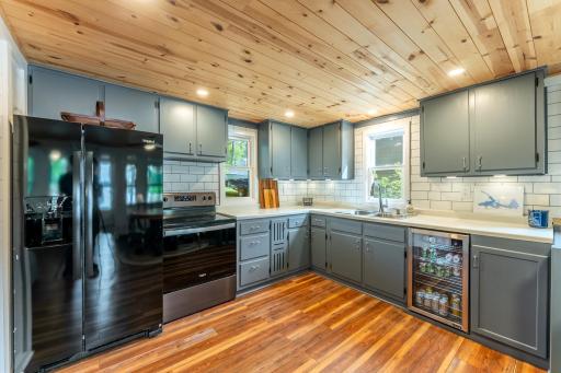 Updates in kitchen include backsplash, beverage fridge and appliances.