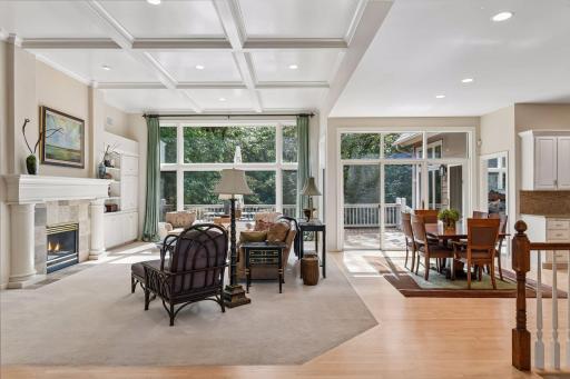 Light-filled great room with soaring coffered ceiling, expansive windows and an open layout connecting the main living spaces.