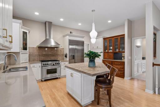 Custom coffee bar and pantry add functionality to the kitchen spaces.