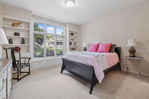 Second main level bedroom features built-in window seat, bookshelves and en-suite full bath.