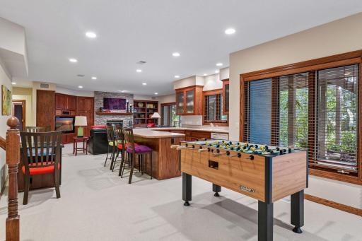 Finished lower level includes a full wet bar with extensive cabinetry, island seating and space for entertaining.