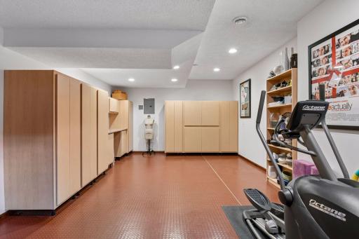 Dedicated exercise or hobby room features durable rubber flooring, tons of storage and generous open space.