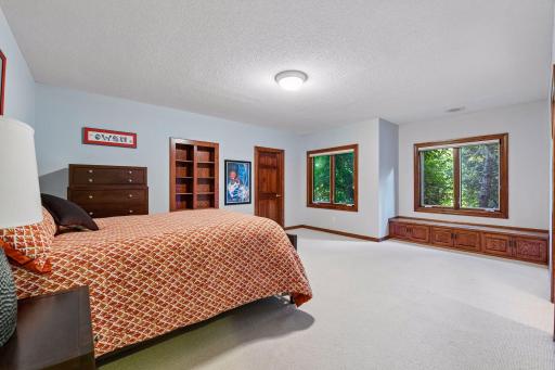 4th bedroom with hidden room behind bookshelves, walk-in closet and built-in window seat.