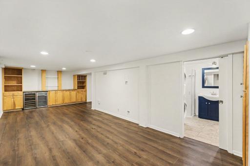 Huge lower level living room with bar, cabinets and new floor!