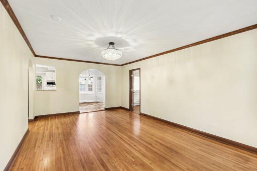 Living room opens up through archway into form dining and kitchen