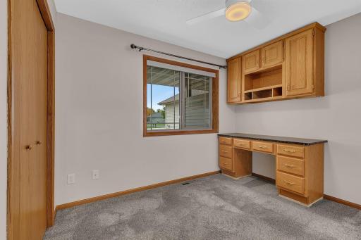 Bedroom 2 on the main floor offers a built-in desk