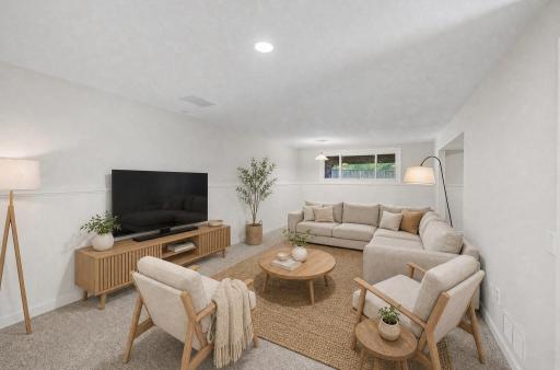 Virtual staged family room. New carpet in lower level Professionally painted