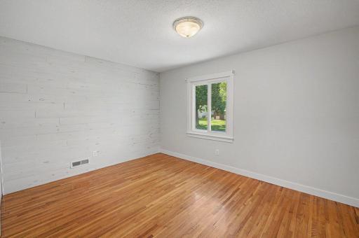Primary bedroom on Main level. Beautiful hardwood floors. You can see in this picture the fresh paint that has been done in the home.