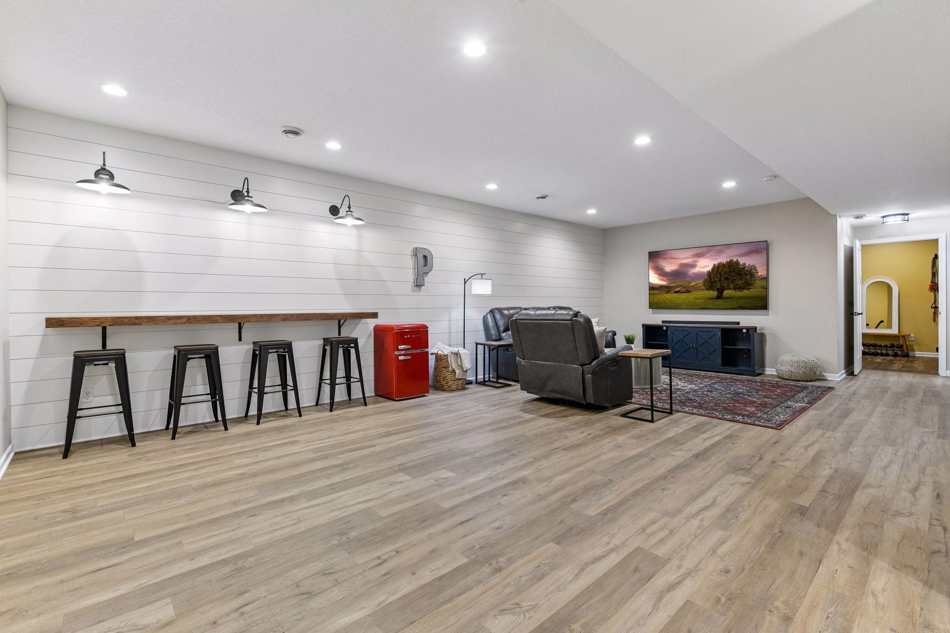 Expansive finished lower level provides incredible space for entertaining, movie nights, games, or relaxing. Featuring updated flooring, a stylish shiplap accent wall, and flexible gathering areas, this level is ready for any lifestyle.