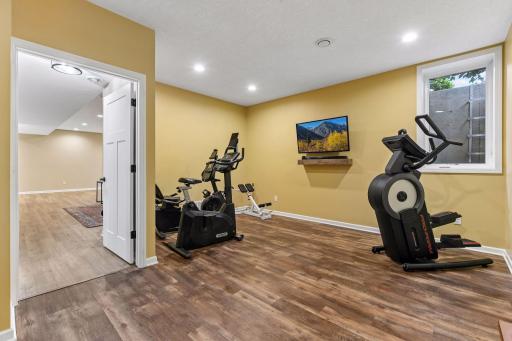 Versatile lower-level room offers endless possibilities as a home gym, fifth bedroom, hobby room, or private guest space. Bright and spacious with updated flooring, this flexible area adapts easily to your lifestyle and needs.