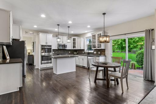 Bright and spacious eat-in kitchen, the heart of the home. Sliding glass doors open to the patio and private backyard creating the perfect space for everyday living.