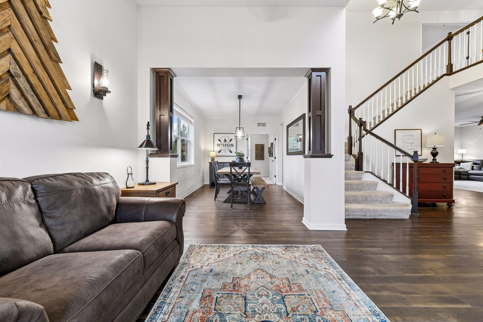 Elegant 2-story entry with soaring ceilings, rich hardwood-style floors, an open flow to the formal dining area. Stunning staircase and architectural details create a bright, welcoming first impression perfect for entertaining and everyday living.