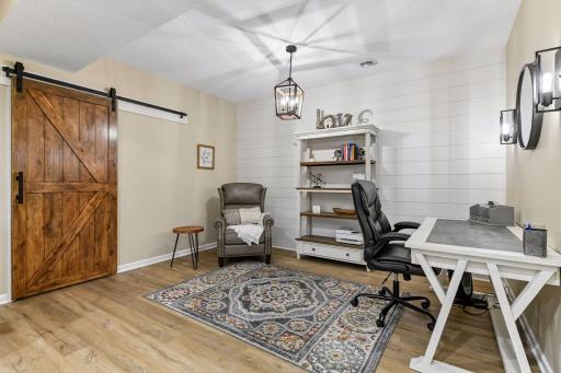 Finished lower level offers exceptional flexibility with a stylish 2nd office, study, or hobby space featuring updated flooring, shiplap accent wall, and rustic barn door. A perfect retreat for working from home, projects, or additional living space.