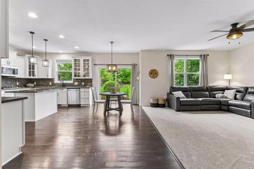 Open-concept living and dining area filled with tons of natural light and scenic backyard views. The seamless layout connects effortlessly to the kitchen, creating the perfect space for everyday living, entertaining or gathering with family