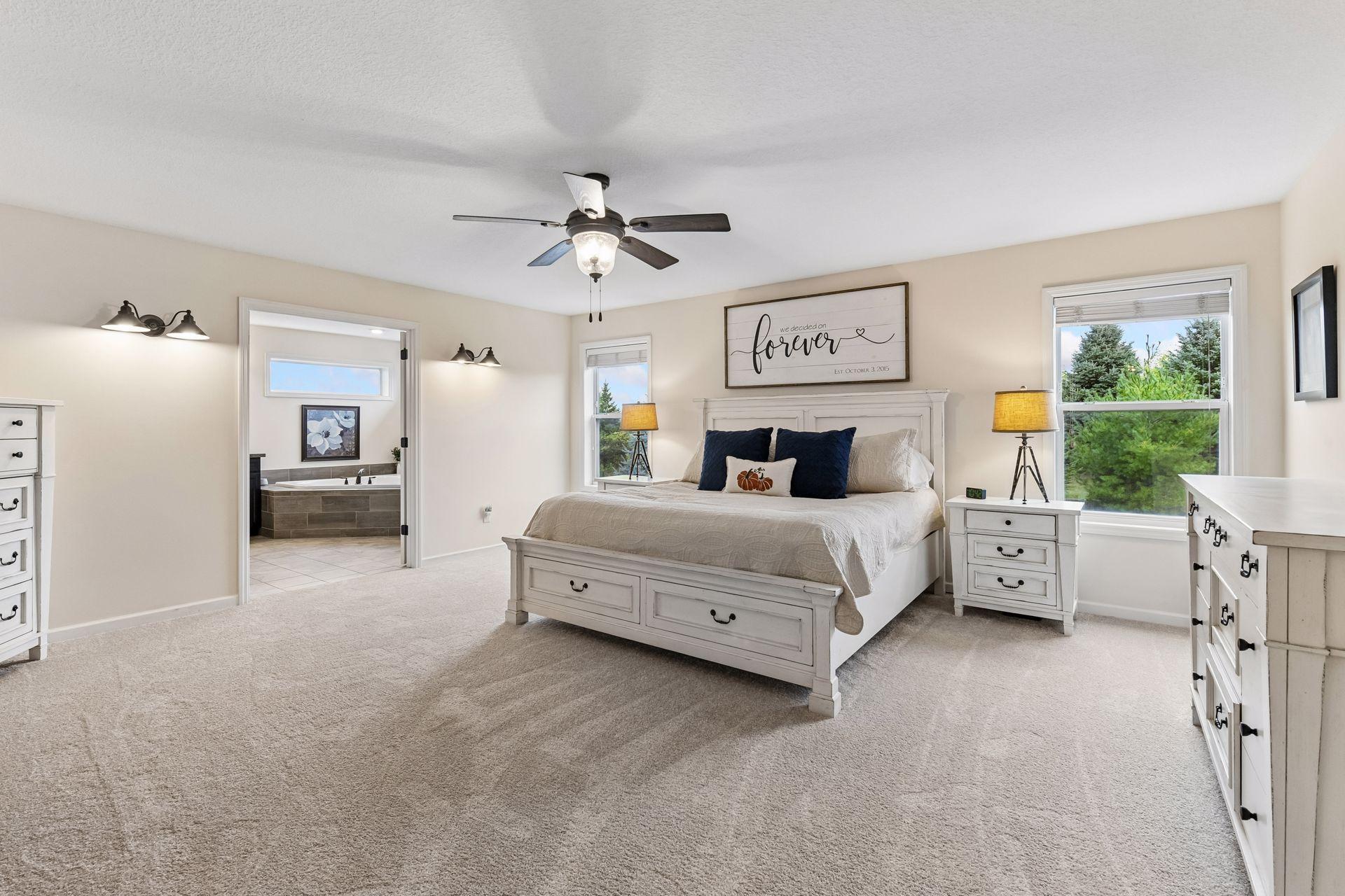 Spacious primary suite offers a peaceful retreat with room for a sitting area, large windows overlooking the backyard, and a private ensuite bath. Relax and unwind in this bright, comfortable space designed for everyday luxury.