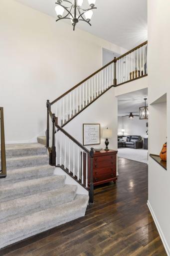 Make a grand first impression with this dramatic two-story foyer featuring soaring ceilings, rich flooring, and an elegant open staircase. Flooded with natural light, this welcoming entry sets the tone for the home's spacious and inviting design.