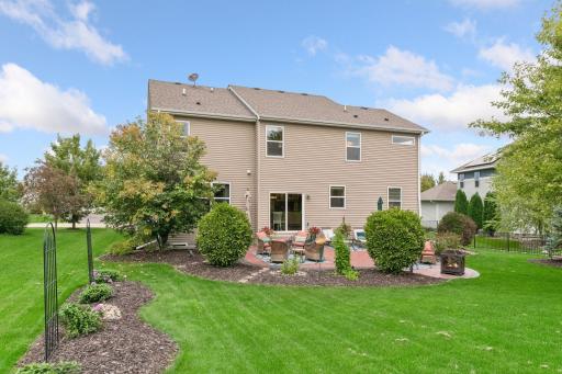 Beautifully landscaped backyard with open green space and private views. Enjoy privacy, room to relax or entertain, for seamless indoor-outdoor living.