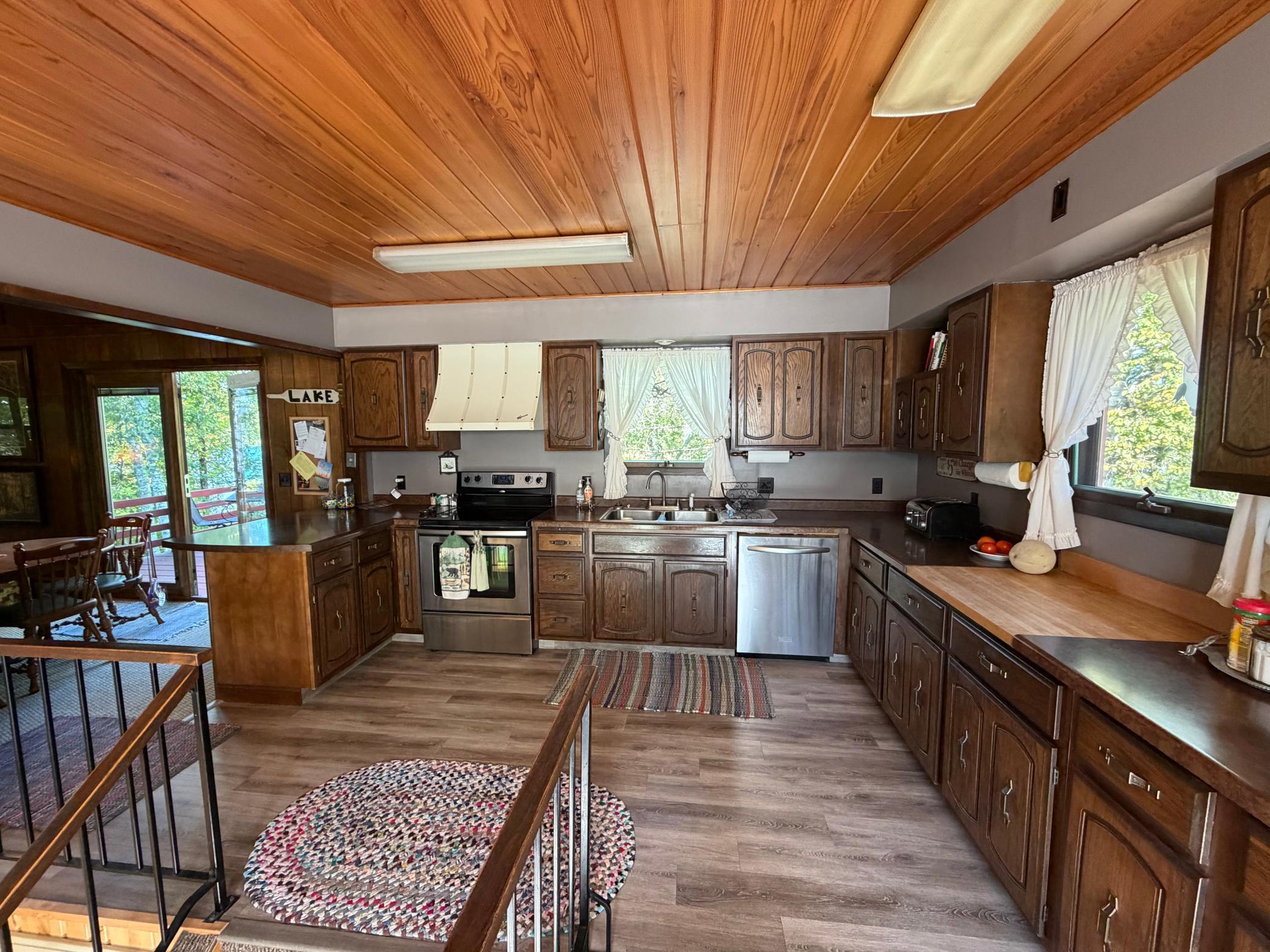 Open-concept with a large kitchen filled with sunlight, a lot of cabinet and counter space and new flooring.