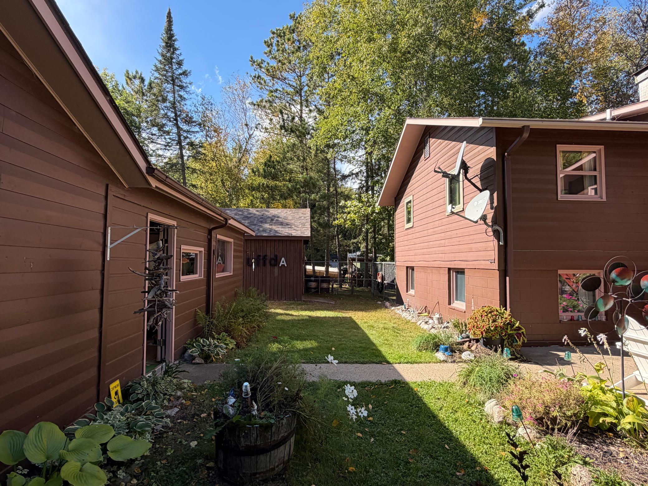 Gorgeous landscaping throughout. This is a fenced-in area between the home and garage.