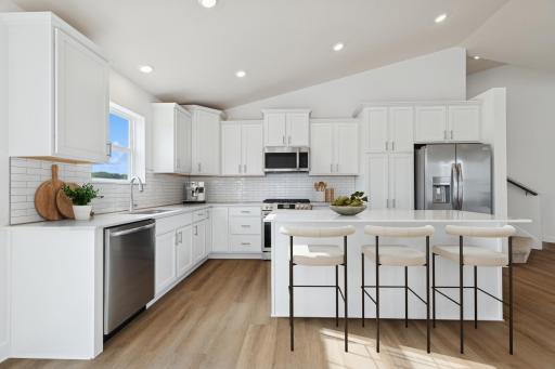 (Photo of similar home features will vary) The kitchen extends into the dining room for effortless transitions between cooking and eating(Photo of similar home features will vary) The kitchen extends into the dining room for effortless transitions be