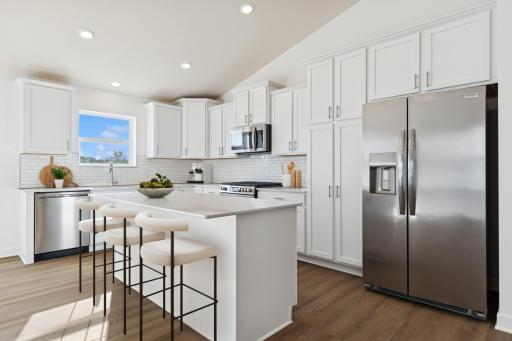 (Photo of similar home features will vary) Designed for adventurous cooks, the well-equipped kitchen showcases extensive flat panel cabinetry for ample storage room, gleaming quartz countertops and cutting-edge features to simplify mealtimes.