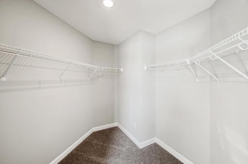 (Photo of model home, actual features may vary) The oversized walk-in closet with mesh-wire shelving provides ample room to store summer and winter wardrobes