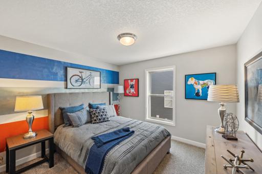 (Photo of model home, actual features may vary) Two secondary bedrooms are nestled in a private corner away from the main living areas, perfect for offering a peaceful retreat after a busy day.