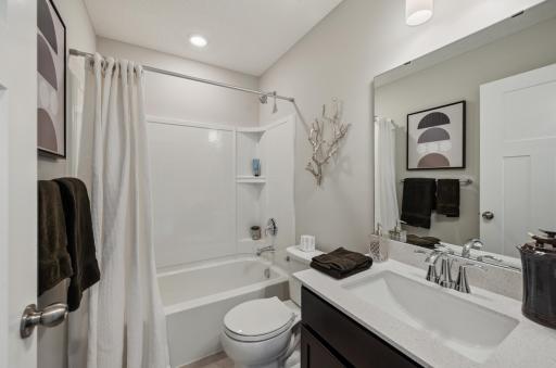 (Photo of model home, actual features may vary) This upper-level full bathroom features an undermount sink with MoenÂ® faucet and a combination tub and shower for style and convenience.