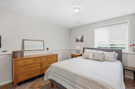 Lower level guest 4th bedroom off of family room with neighboring 3/4 bathroom.