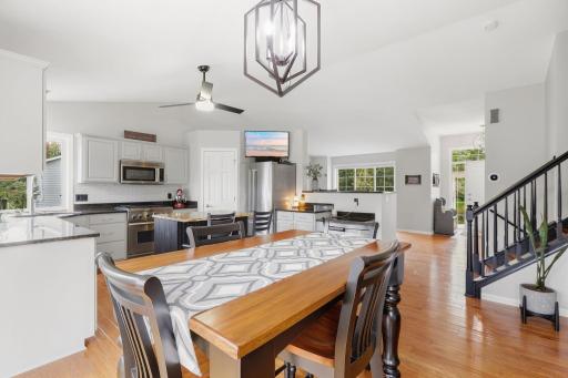 Panoramic view of kitchen, dining area, front living room & entryway, note updated lighting.