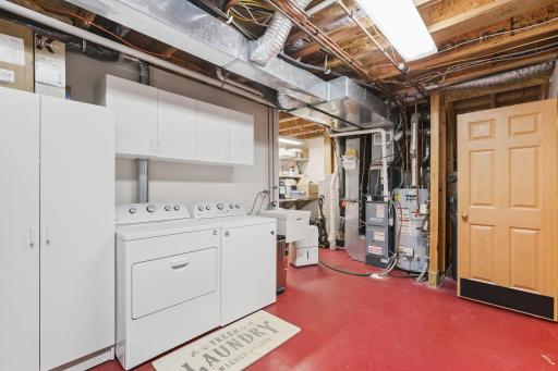 Laundry, mechanical room with laundry tub, newer mechanicals including furnace & hot water heater