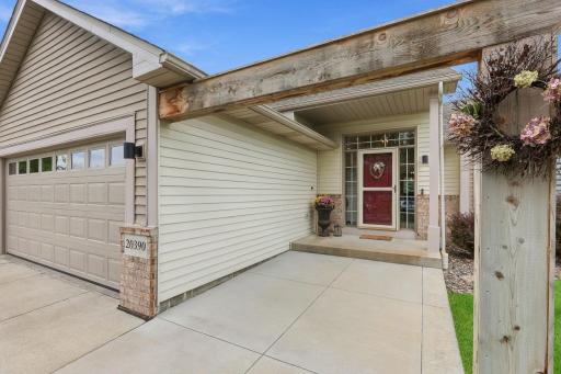 Concrete poured entryway, front patio with decorative beam.